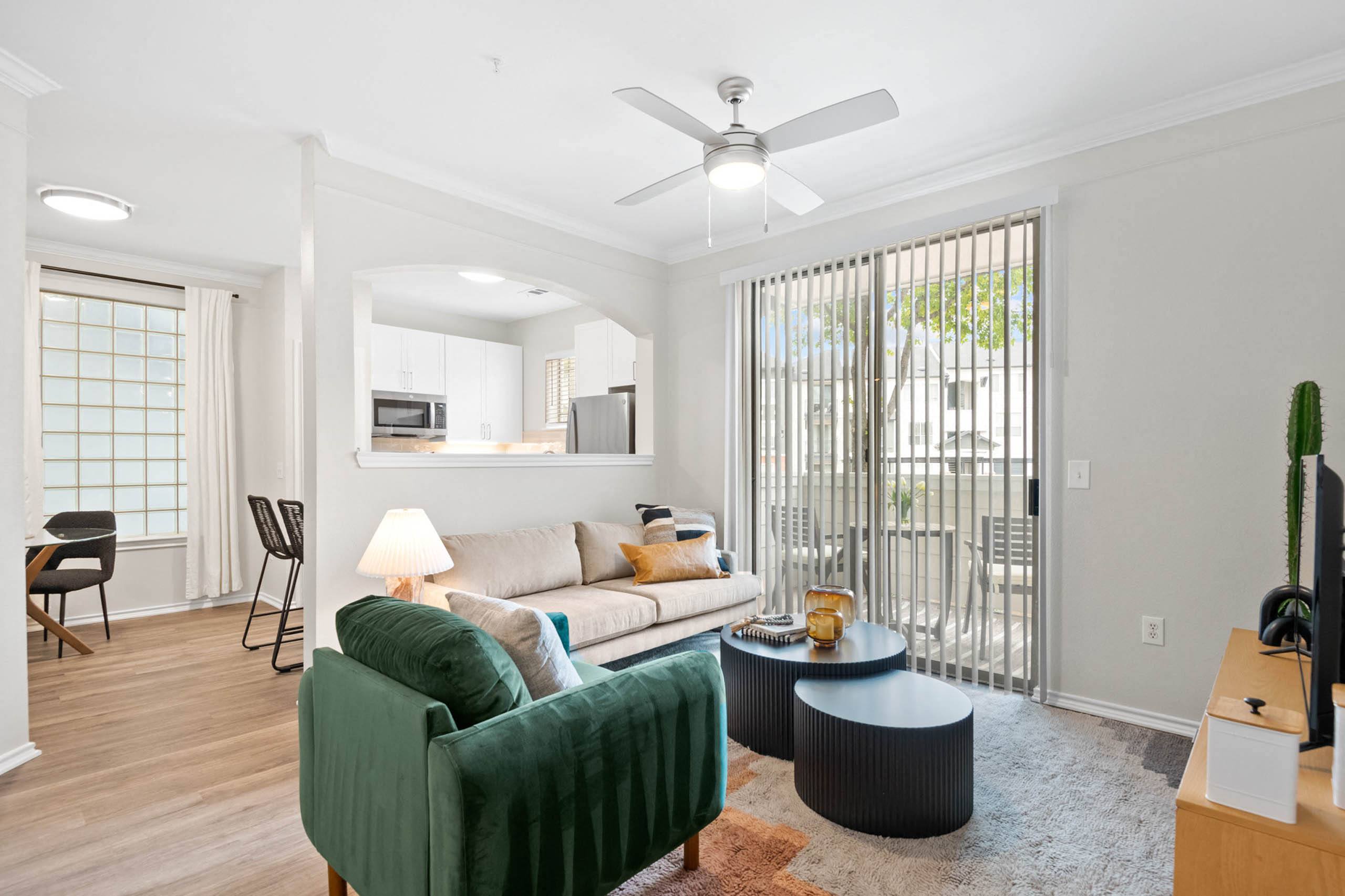 a living room with a couch and a ceiling fan